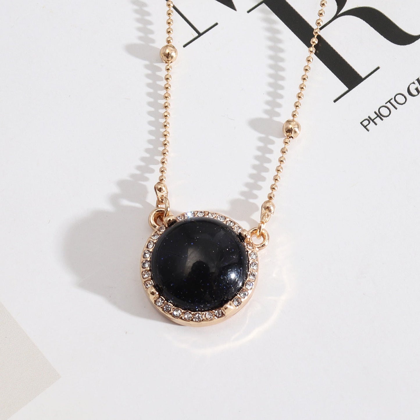 Natural Stone Dome Style Gold Pendant Surrounded by Sparkling Gems.