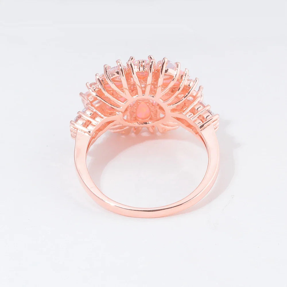 Large Pink Fire Opal Stone Rose Gold Crystal Flower Ring Adorned with Dazzling Gemstones.