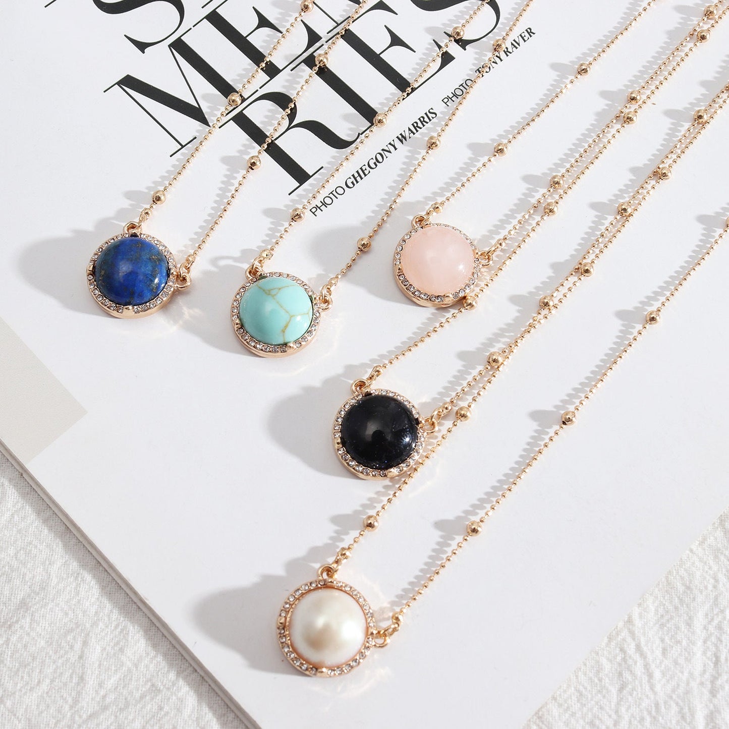 Natural Stone Dome Style Gold Pendant Surrounded by Sparkling Gems.