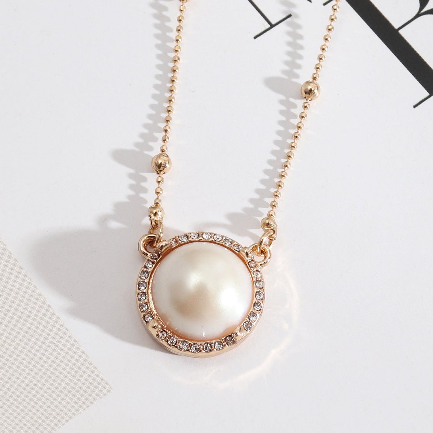 Natural Stone Dome Style Gold Pendant Surrounded by Sparkling Gems.