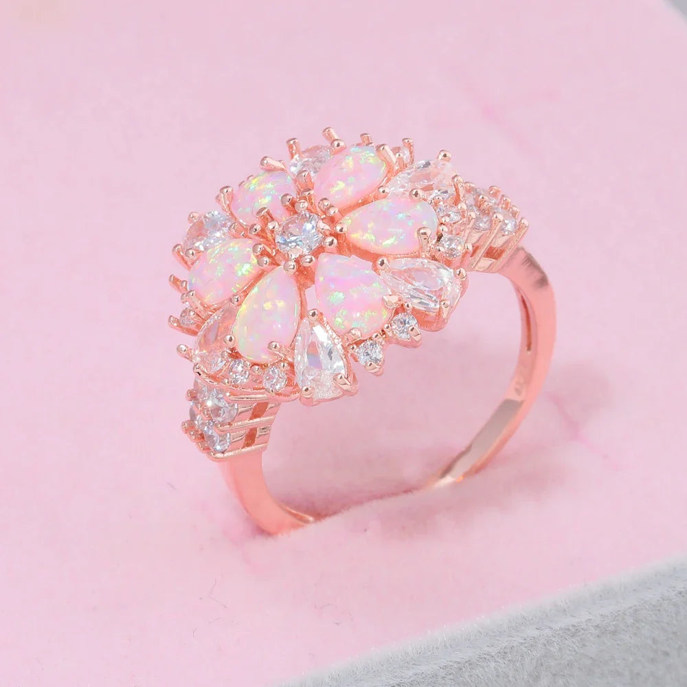 Large Pink Fire Opal Stone Rose Gold Crystal Flower Ring Adorned with Dazzling Gemstones.