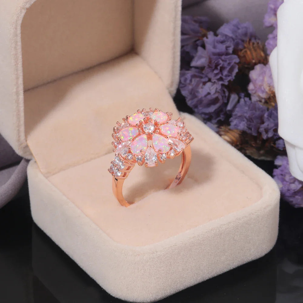 Large Pink Fire Opal Stone Rose Gold Crystal Flower Ring Adorned with Dazzling Gemstones.